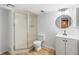 Updated bathroom featuring a shower, toilet, and vanity with modern fixtures at 2090 S Fairplay St, Aurora, CO 80014