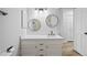 Modern bathroom with updated vanity, sink, hardware, and circular mirrors at 2090 S Fairplay St, Aurora, CO 80014
