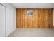 Bedroom with carpet floors, a wood paneled accent wall, and a window for natural light at 2090 S Fairplay St, Aurora, CO 80014