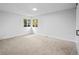 Sun-filled bedroom boasts neutral walls and carpet, plus large windows at 2090 S Fairplay St, Aurora, CO 80014