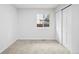 Clean bedroom featuring light-colored carpet, closet, and a bright window at 2090 S Fairplay St, Aurora, CO 80014