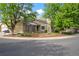 Beautifully landscaped exterior with mature trees, a charming entrance, and a two-car garage at 2090 S Fairplay St, Aurora, CO 80014