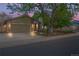 Charming home featuring a two-car garage, well-lit exterior, and a beautifully landscaped front yard at 2090 S Fairplay St, Aurora, CO 80014
