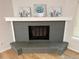 Modern fireplace with a gray brick surround, white mantle, and decorative art at 2090 S Fairplay St, Aurora, CO 80014
