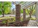Charming front porch with stone pillars, pergola detail, metal railing, and landscaped surroundings at 2090 S Fairplay St, Aurora, CO 80014