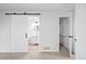 Hallway leading to a full bath and closet with wood floors at 2090 S Fairplay St, Aurora, CO 80014
