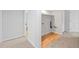 View of the unfinished laundry area with wood-look floors and white walls at 2090 S Fairplay St, Aurora, CO 80014