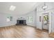 Bright living room features wood-look floors, vaulted ceilings, skylights, and a cozy fireplace at 2090 S Fairplay St, Aurora, CO 80014