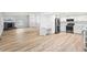 Open-concept living room with modern flooring, fireplace, and a bright, updated kitchen at 2090 S Fairplay St, Aurora, CO 80014