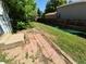 Fenced backyard with a brick patio, green grass, and mature trees offering shade on a bright, sunny day at 3984 S Pitkin Way, Aurora, CO 80013