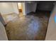 View of open basement space with an unfinished floor, adjacent to a bathroom at 3984 S Pitkin Way, Aurora, CO 80013