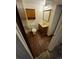 Bathroom with wood cabinet, mirror, and toilet with wood-look flooring at 3984 S Pitkin Way, Aurora, CO 80013