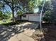 Home featuring a front-facing two-car garage, and a lawn with mature trees needing some TLC at 3984 S Pitkin Way, Aurora, CO 80013