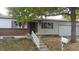 Ranch style home with brick facade, attached garage, and mature landscaping at 3984 S Pitkin Way, Aurora, CO 80013