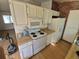 A kitchen with a range, microwave, and refrigerator ready to be updated at 3984 S Pitkin Way, Aurora, CO 80013