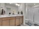 Clean bathroom with double sinks, modern fixtures, and a glass-enclosed shower at 21821 E 7Th Ave, Aurora, CO 80018