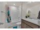 Well-lit bathroom features a shower over tub, neutral tile, and a modern vanity at 21821 E 7Th Ave, Aurora, CO 80018
