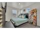 Comfortable bedroom featuring a plush bed, natural light, and a collection of stuffed animals at 21821 E 7Th Ave, Aurora, CO 80018