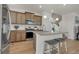 Modern kitchen with stainless steel appliances, a granite island, and beautiful hardwood floors throughout the space at 21821 E 7Th Ave, Aurora, CO 80018