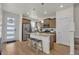 Modern kitchen with stainless steel appliances, a granite island, and beautiful hardwood floors throughout the space at 21821 E 7Th Ave, Aurora, CO 80018