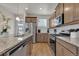 Modern kitchen with stainless steel appliances, a granite island, and beautiful hardwood floors throughout the space at 21821 E 7Th Ave, Aurora, CO 80018