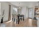 Bright living room featuring hardwood floors, a modern table, and view to the exterior at 21821 E 7Th Ave, Aurora, CO 80018