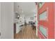 Open-concept space featuring modern decor, a comfortable living area, and stylish flooring viewed through red front door at 21821 E 7Th Ave, Aurora, CO 80018