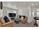 Bright living room with a comfortable seating area with beige sofas and stylish decor at 21821 E 7Th Ave, Aurora, CO 80018