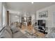 Open-concept living room with hardwood floors flowing into a bright kitchen and dining area at 21821 E 7Th Ave, Aurora, CO 80018