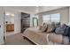 Serene main bedroom featuring a plush bed with ample pillows and a view into the en suite bathroom at 21821 E 7Th Ave, Aurora, CO 80018