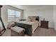 Cozy bedroom with large window, stylish furniture, and a comfortable seating area at 21821 E 7Th Ave, Aurora, CO 80018