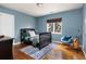 Stylish bedroom with a dark wood bed frame, a cool blue accent wall, and hardwood floors at 30 Eudora St, Denver, CO 80220