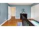 Spacious bedroom features hardwood floors and a blue accent wall at 30 Eudora St, Denver, CO 80220