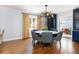 Open dining room with hardwood floors, chandelier, grey chairs, round table, and yellow patterned curtains at 30 Eudora St, Denver, CO 80220