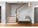 Beautiful wooden staircase with white risers, hardwood floors, and a light gray wall color at 30 Eudora St, Denver, CO 80220