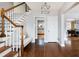 Lovely staircase and foyer features a wooden staircase, hardwood floors, and a modern chandelier at 30 Eudora St, Denver, CO 80220