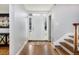 Open foyer with a bright entryway, hardwood floors, and stylish console table with modern art at 30 Eudora St, Denver, CO 80220