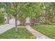 Charming brick home with a beautiful stone walkway leading to the front door and a well-manicured lawn at 30 Eudora St, Denver, CO 80220
