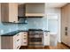Stylish kitchen features light wood cabinetry, stainless steel appliances, and a sleek range hood at 30 Eudora St, Denver, CO 80220