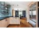 Open kitchen with wood cabinets, a stainless steel refrigerator, and an open view into the dining area at 30 Eudora St, Denver, CO 80220