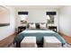 Bright main bedroom features two bedside tables, soft decor, and views from the dual windows at 30 Eudora St, Denver, CO 80220