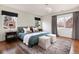 Inviting main bedroom with hardwood floors, windows with blackout shades, and a comfy bed with accent pillows at 30 Eudora St, Denver, CO 80220