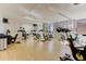 Bright gym featuring rows of exercise bikes, large windows, and hardwood floors at 1700 Bassett St # 412, Denver, CO 80202