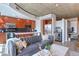 Stylish living room with open kitchen featuring stainless steel appliances and concrete ceiling at 1700 Bassett St # 412, Denver, CO 80202