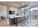 Bright open living area with dining bar and access to outdoor balcony with seating at 1700 Bassett St # 412, Denver, CO 80202