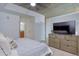 Bright bedroom with large TV, dresser, and access to ensuite bathroom at 1700 Bassett St # 412, Denver, CO 80202