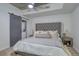 Cozy bedroom featuring a modern upholstered headboard, barn door, and laundry closet at 1700 Bassett St # 412, Denver, CO 80202