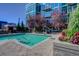 Modern pool area with flowers and trees and building views at 1700 Bassett St # 412, Denver, CO 80202