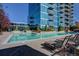 Inviting pool area with lounge chairs and lush landscaping surrounding building at 1700 Bassett St # 412, Denver, CO 80202