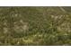 Aerial view of the property surrounded by a forest of trees on a rocky mountain at 35106 Boulder Canyon Dr, Boulder, CO 80302